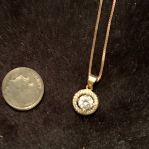 Round CZ stone surrounded by circle of cz's